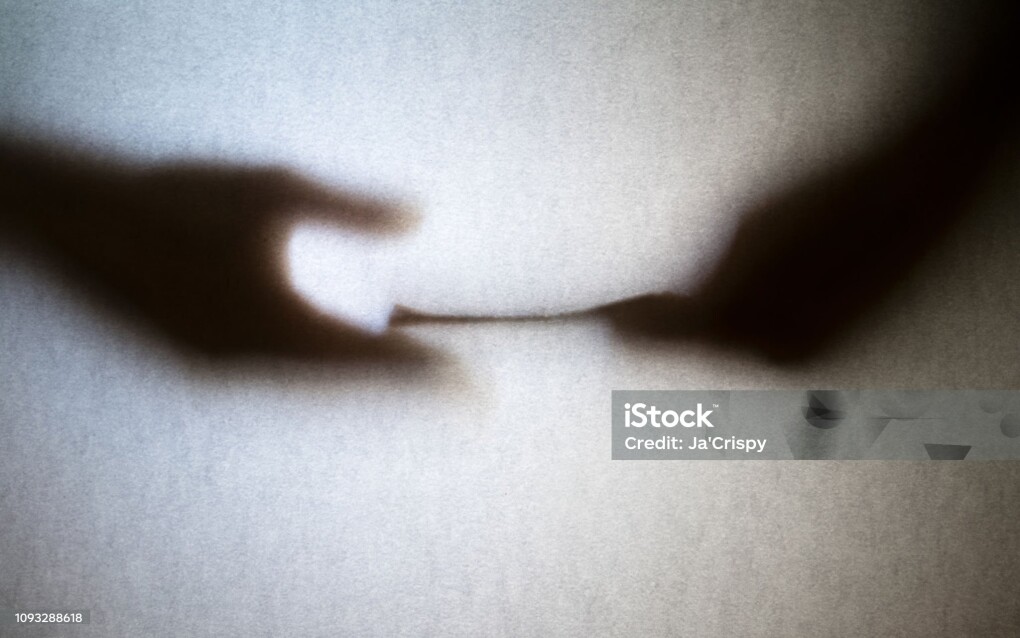 Silhouette of business man hands giving bribe isolated on grey background