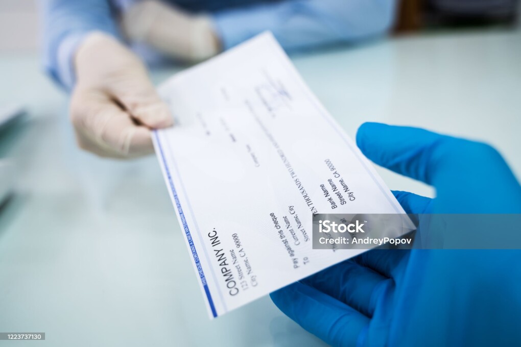 Giving Cheque Of Payroll Check To Employee In Gloves