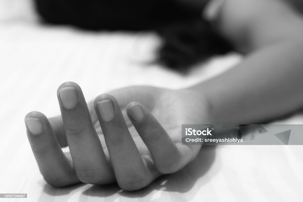 Picture of a numb hand of a woman showing death or unconsciousness