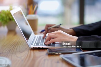Portrait of a beautiful Asian businesswoman using a desktop computer. Businesswoman, statistical analysis, data trading. Marketing