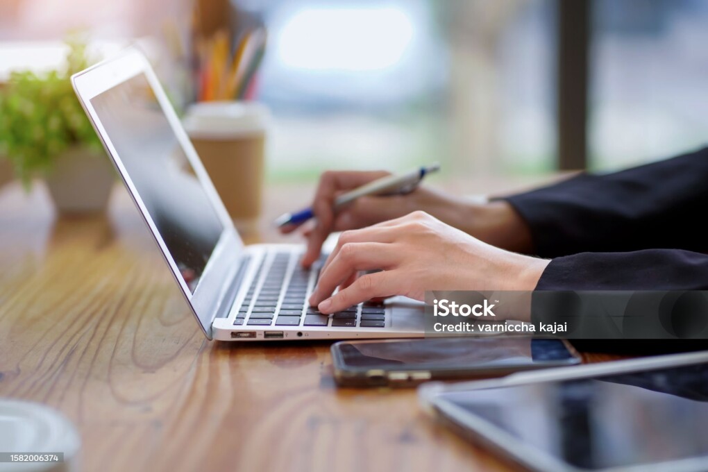 Portrait of a beautiful Asian businesswoman using a desktop computer. Businesswoman, statistical analysis, data trading. Marketing