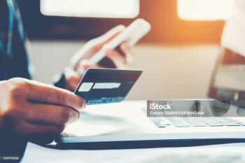 Man Holding Credit Card And Using Cell Phone holding credit card with shopping online