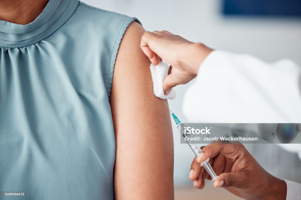 Hands, medical and doctor with patient for vaccine in a clinic for healthcare treatment for prevention. Closeup of a nurse doing a vaccination injection with a needle syringe in a medicare hospital.