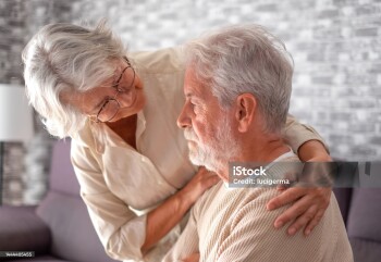 Old worried senior woman comforting her depressed, mental ill husband, unhappy elderly man at home need medical help. Ourmindsmatter