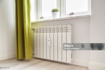 Heating white radiator radiator in living room.