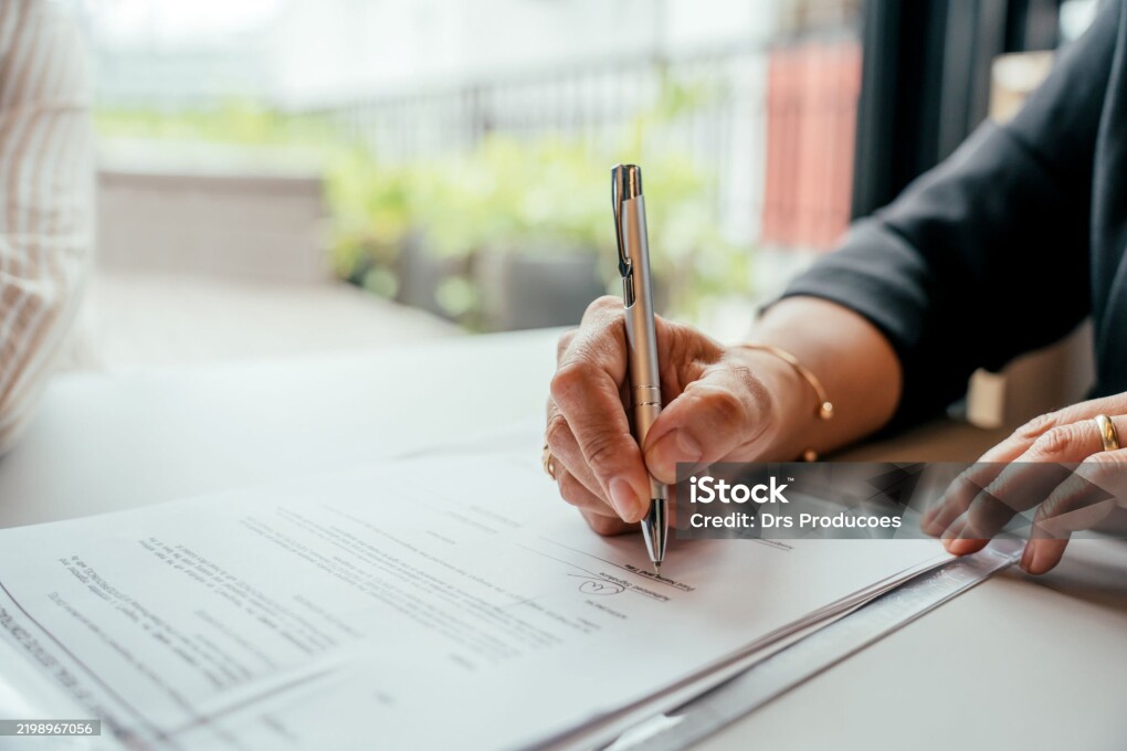 Couple closing real estate contract with real estate agent