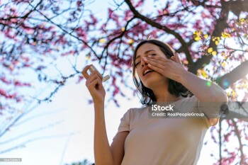 Asthmatic Woman Suffers From Asthma and is Using Inhaler in the Public Park. Chronic Disease Control, Allergy Induced Asthma Remedy and Chronic Pulmonary Disease Concept.