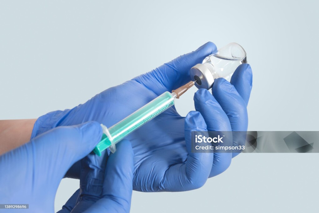 Doctor holding a vial with a vaccine. flu and coronavirus vaccinations concept