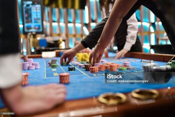 Female and Male Having Fun in Luxurious Casino Rearranging Gambling Chips