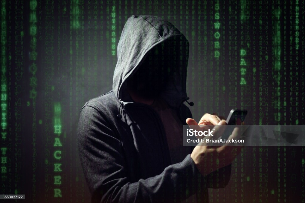Computer hacker with mobile phone smartphone stealing data