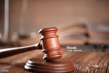 Lawyers office. Gavel on the rustic brown desk.