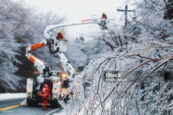 Linesman work to restore power during an intense ice storm.