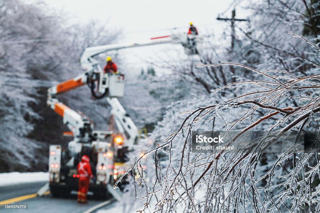 Linesman work to restore power during an intense ice storm.