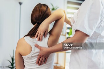 Teen Girl having chiropractic back adjustment. Osteopathy, Physiotherapy, Kinesiology. Bad posture correction