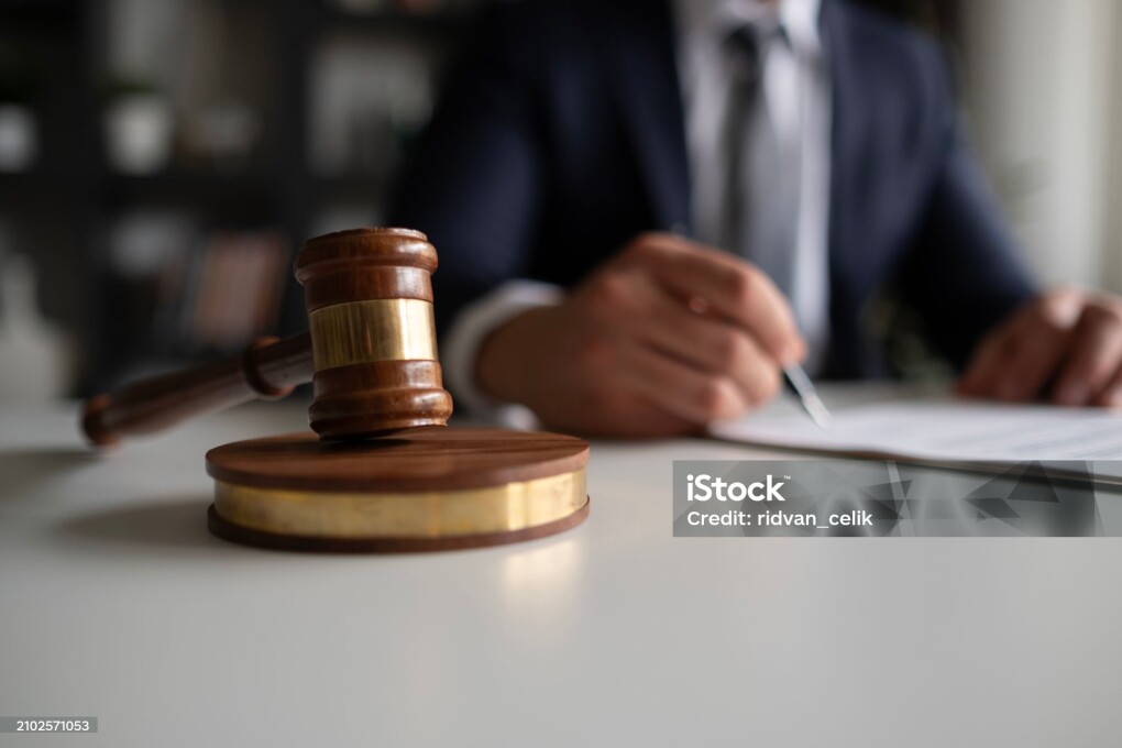 Judge or Legal advisor lawyer examining and signing legal documents.