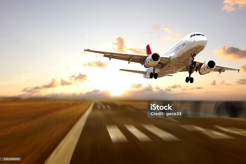 Passenger airplane landing at sunset