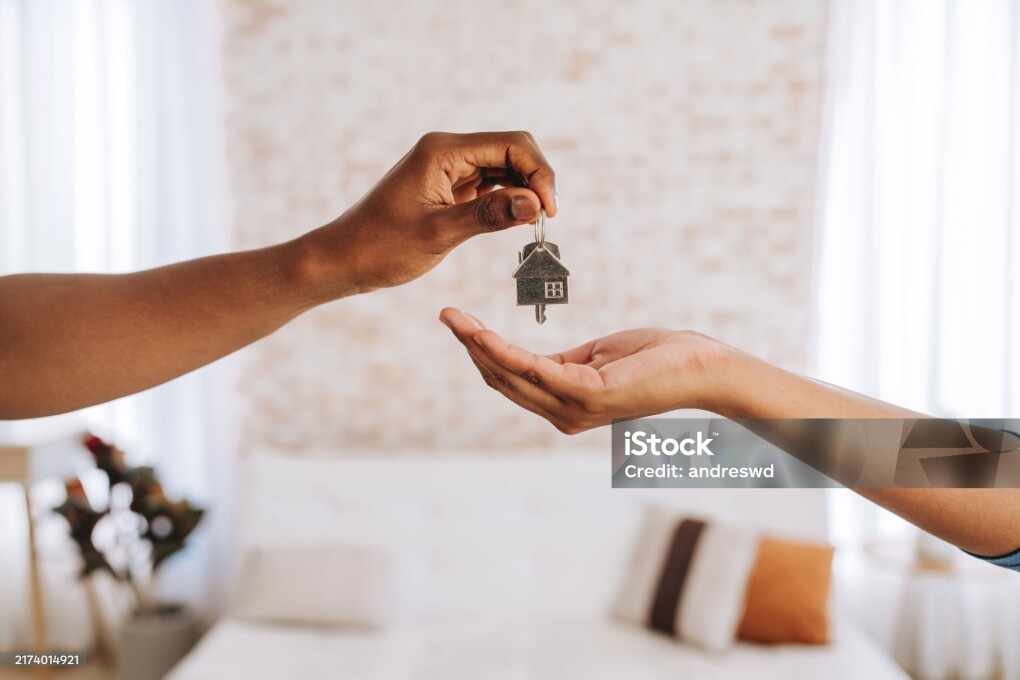 Real estate agent giving a man the keys to his new home