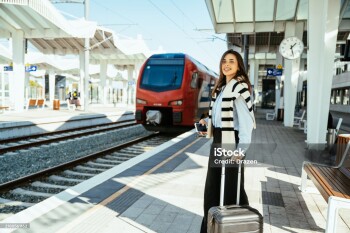 Businesswoman on business trip, at railway station