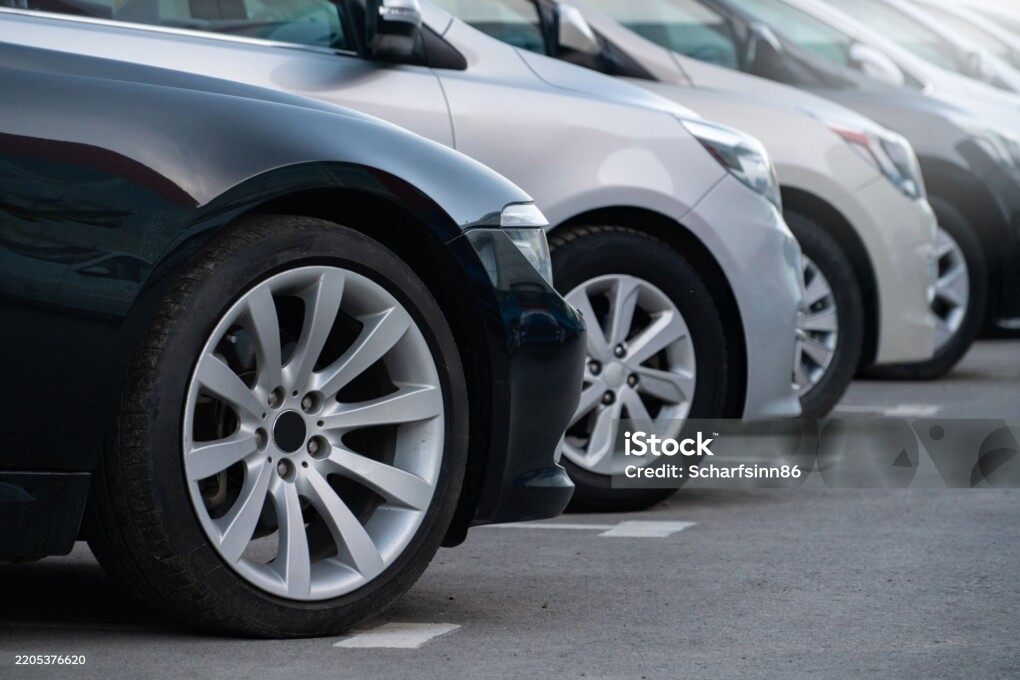A lot of cars in a rows. Used car sales.