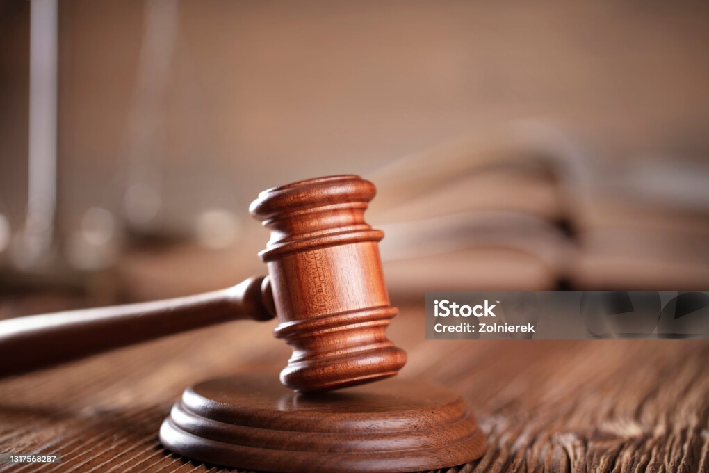 Lawyers office. Gavel on the rustic brown desk.