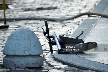 Broken scooter on the road after an accident