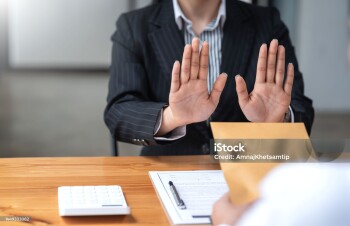 Authorities raising his hand refusing to accept bribes from customer.