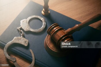 Handcuffs and wooden gavel. Crime, legal and violence concept.