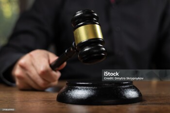 judge's gavel in hand judges is placed on a table in the legal counsel's office and is often used before verdicts are read to plaintiffs, and defendants in court