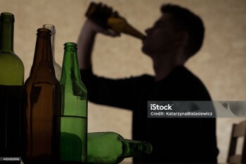 Alcoholism among young people - teenager drinking beer