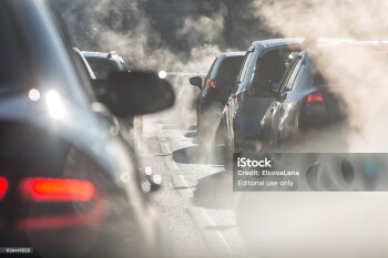 Moscow, Russia - August 08, 2017: Traffic jam. Blurred silhouettes of cars surrounded by steam from the exhaust pipes. Environmental pollution