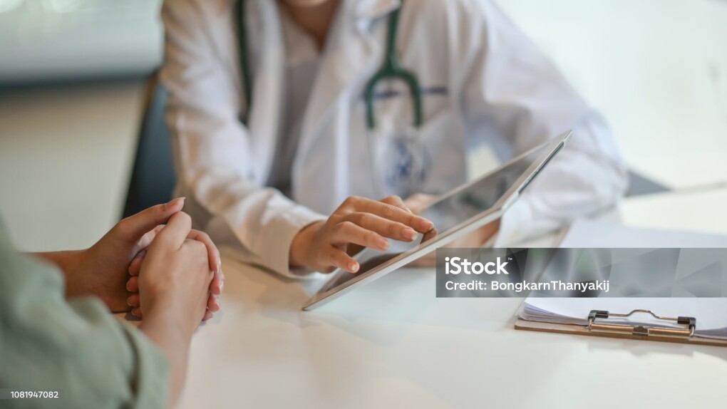 Shot of a doctor showing a patient some information on a digital tablet