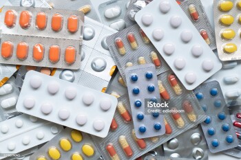 Background of a large group of assorted capsules, pills and blisters