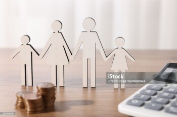 Alimony. Figures of family, coins and calculator on wooden table, closeup