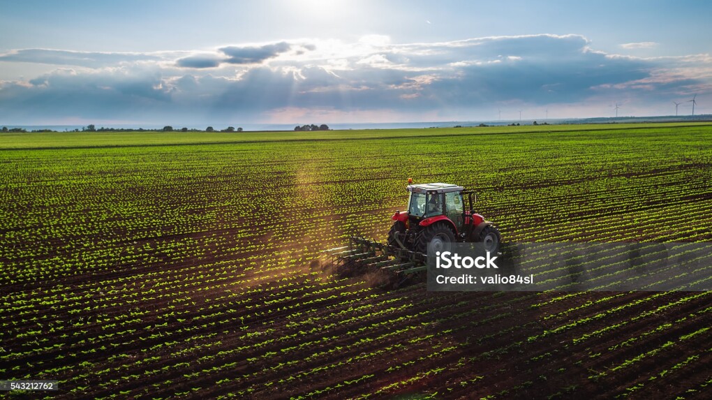 Tractor cultivating field at spring,aerial view