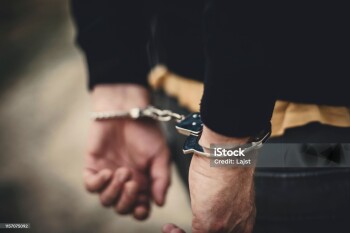 Man in handcuffs behind his back