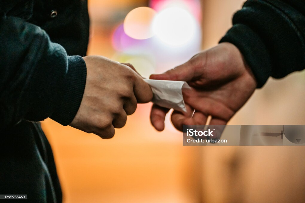 Addict young man have meeting with dealer at night to buy dose of white powder cocaine.
