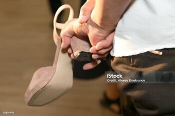 A woman's shoe in a man's hand of a thief at a wedding, a custom