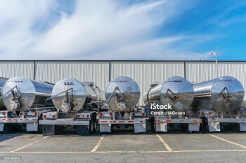 Row shiny metal tanker trucks