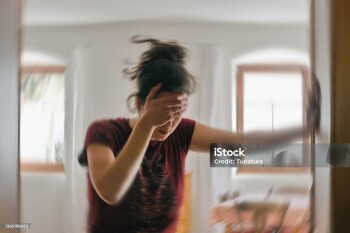 Woman suffering from vertigo or dizziness or other health problem of brain or inner ear.
