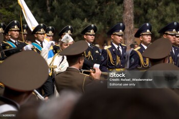 Victory Day is a celebration day that commemorates the victory of the Soviet Union over Nazi Germany in the Great Patriotic War. (Second World War). In Kazakhstan on the 9th of May the people remembering their Heros in the Panfilov Park. The image shows a military music group, captured during springtime.