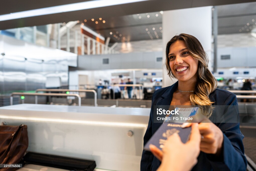 Airline attendant picking the passenger's passport at the airport