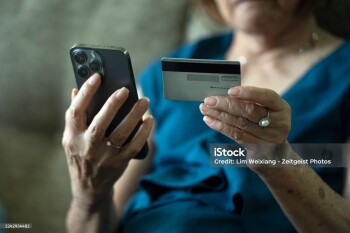 Elderly asian chinese woman being contacted by telephone scammer