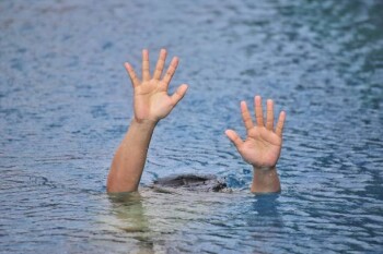 Man drowning in out door swimming pool while swimming alone, show two hands and asking for help
