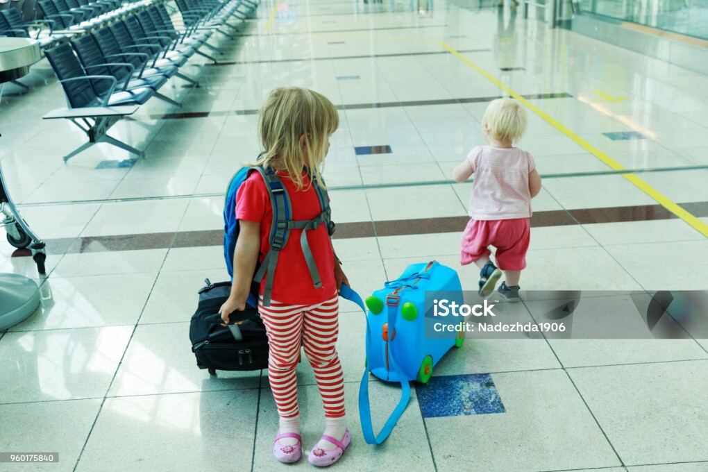 kids with suitcase travel in the airport, family travel