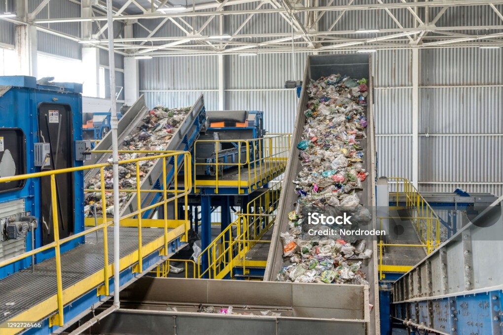Waste sorting and recycling plant. Garbage moves on a conveyor belt.