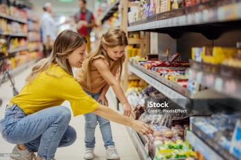 Mother and little girl daughter shopping in the supermarket