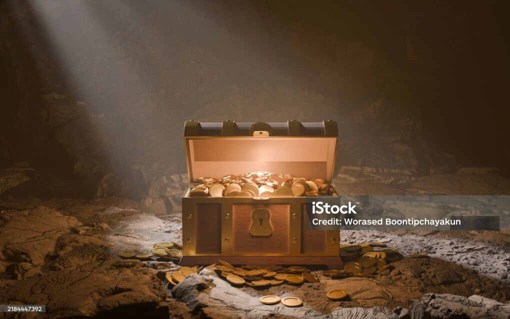 Treasure Chest in the Spotlight: A treasure chest overflowing with gold coins is dramatically lit by a single spotlight in a mysterious cave setting