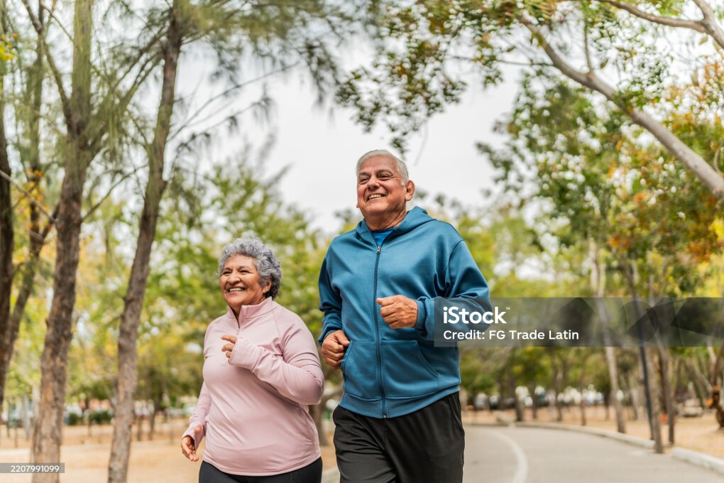 Senior couple talking and running on public park