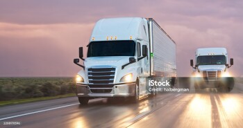 A semi-truck driving south on Interstate 5 in the Central Valley on a stormy evening.