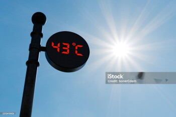 Street digital thermometer displaying a temperature of 43 degrees Celsius with blue sunny background. . High quality photo